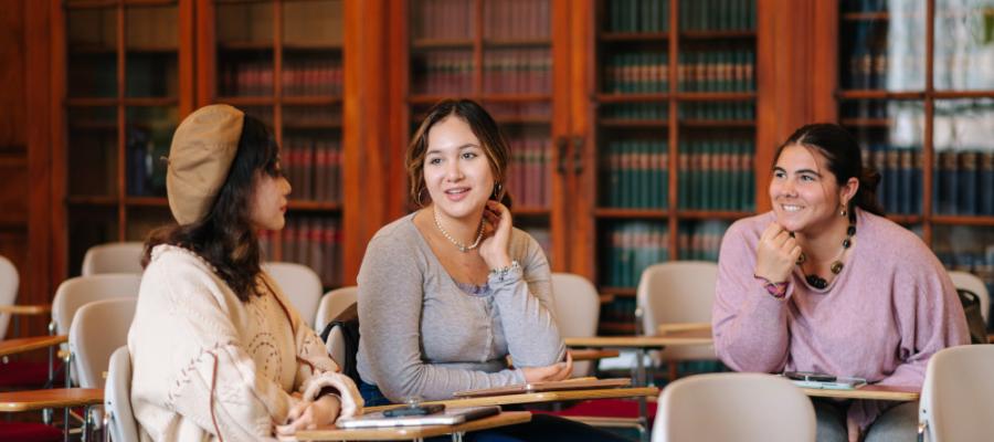 Three students in a library